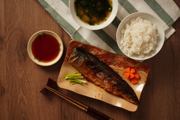 Japan food, Grilled saba or mackerel with sweet sauce served with miso soup and cooked rice placed on wooden table