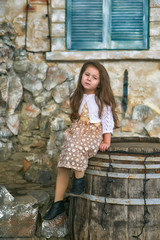 Beautiful fashionable little girl in the city . Model children .