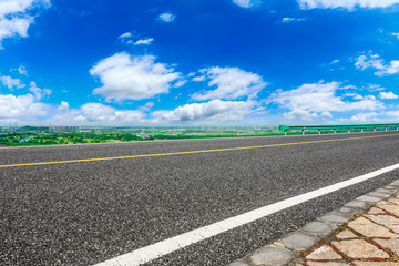 Empty asphalt highway and city suburb skyline on a sunny day in Shanghai.