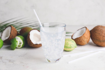 Glass of fresh coconut water on table