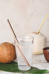 Glass of fresh coconut water on table