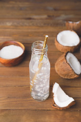 Fototapeta na wymiar Bottle of fresh coconut water on table