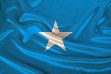 photo of the national flag of Somalia on a luxurious texture of satin, silk with waves, folds and highlights, closeup, copy space, travel concept, economy and state policy, illustration