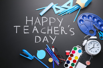 Set of school stationery and text HAPPY TEACHER'S DAY on dark background