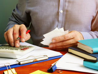 Home budget concept. Man is counting bills and managing finances.