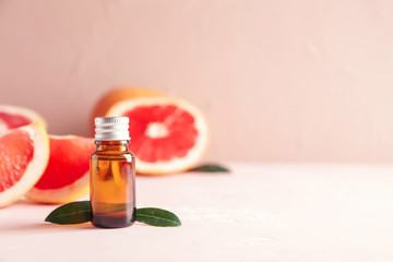 Bottle of grapefruit essential oil on table