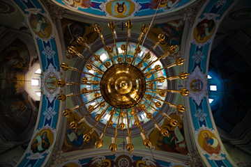 painted ceiling with gold chandelier in vydubychi monastery