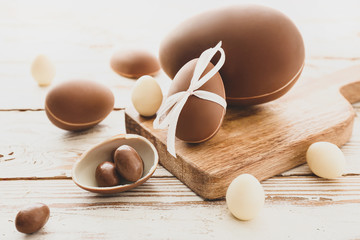 Tasty chocolate Easter eggs on wooden background