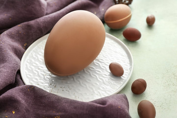 Tasty chocolate Easter eggs on light background