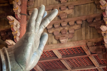 close up of a hand of a giant buddha statue