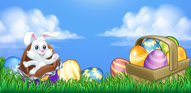 The Easter bunny rabbit breaking out of a chocolate Easter egg in an outdoor scene