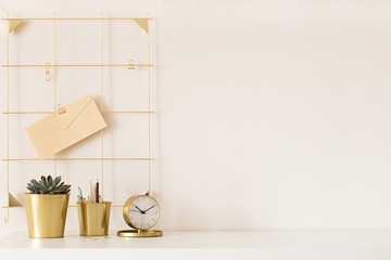 Modern office desk with gold accessories. Empty space, mock up. Minimal style.