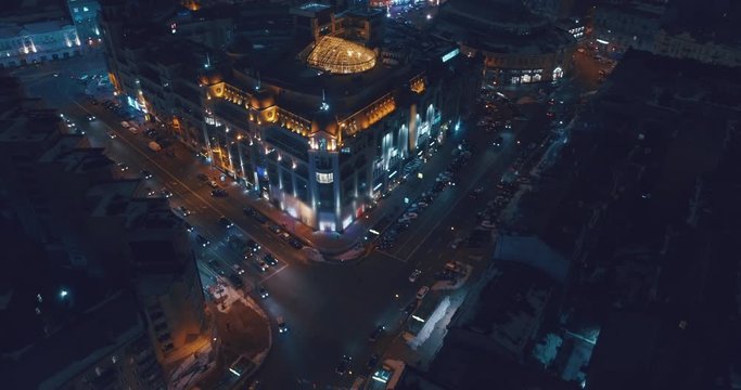 Aerial view of night streets in downtown Kyiv, Ukraine, with bright night illumination. Wide shot with smooth cinematic drone motion D
