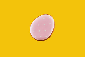 Colorful gingerbread egg isolated on yellow background