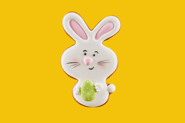 One gingerbread in shape of easter bunny that holding small egg