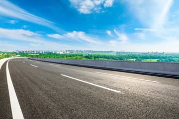 Fototapeta premium Empty asphalt highway and city suburb skyline on a sunny day in Shanghai.