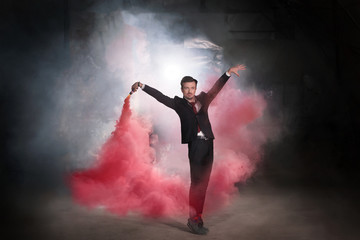 Fototapeta na wymiar Pasadoble, latin solo dance and contemporary dance - Handsome male dancing into smoke cloud.