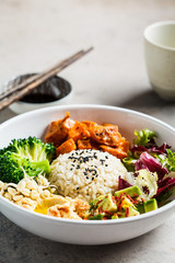 Vegan rice and vegetables salad. Macrobiotic set with rice, hummus, avocado, broccoli and sweet potato.