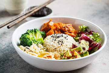 Vegan rice and vegetables salad. Macrobiotic set with rice, hummus, avocado, broccoli and sweet potato.