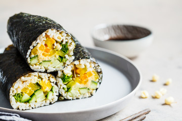 Vegan nori wraps with rice, hummus, vegetables and seedlings.