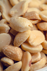 Salted peanuts on rustic background. Selective focus. Shallow depth of field.