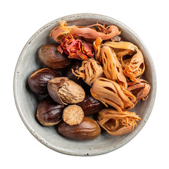 Dried organic mace or jayitri and nutmeg in ceramic bowl isolated on white background. Top view.