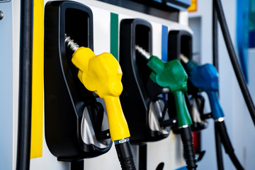 Colorful Petrol pump filling nozzles, Gas station in a service.