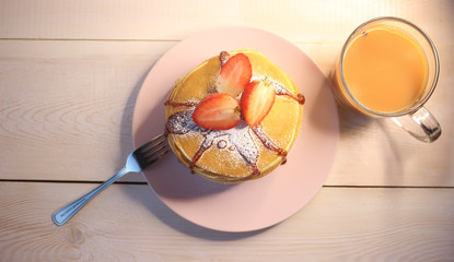 Tea party with delicious, home-made pancakes, jam and strawberries. Top view