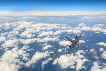 Fototapeta na wymiar Airplane flying at high altitude and beautiful high-altitude clouds in spring