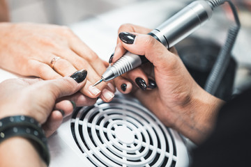 Closeup shot of hardware manicure in a beauty salon.