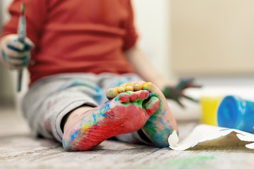 Adorable cute caucasian little blond siblings children enjoy having fun painting with brush and palm at home indoors . Cheerful happy kids smiling drawing masterpiece art picture. Messy dirty room