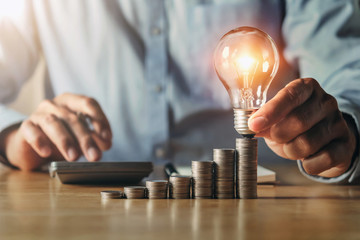 businessman hand holding light bulb. idea concept with innovation and inspiration. idea finance...