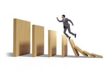 Businessman in domino effect concept