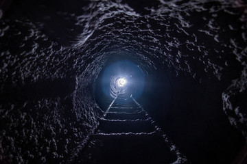 Inside a sewer well with ladder. Photo from bottom to top.