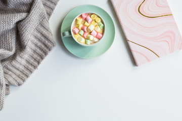 Cup of cocoa with marchmallows on white background