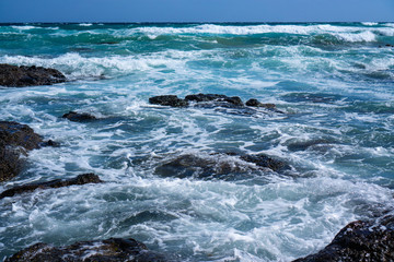 Waves crashing stones