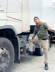 Fototapeta na wymiar Portrait of a truck driver happy smile with giving thumb-up