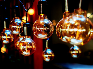 Close-up photo of glossy bulbs hanging on a dark background