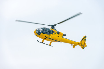 Fototapeta na wymiar yellow helicopter's landing