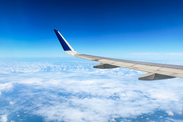 Fototapeta premium Airplane flying at high altitude and beautiful high-altitude clouds in spring