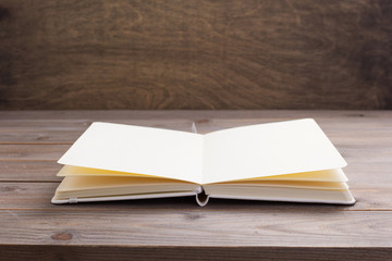 notepad or paper book at wooden table