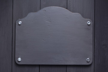 nameplate at black wooden background texture