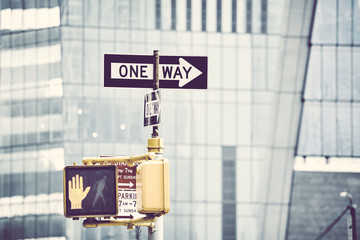 One way street sign with modern building in background, selective focus, color toning applied, New...