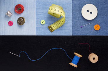 sewing tools and accessories on jeans background