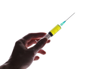 Syringe filled with green liquid held in hand