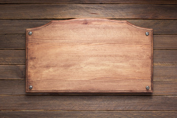 nameplate or wall sign at  wooden background