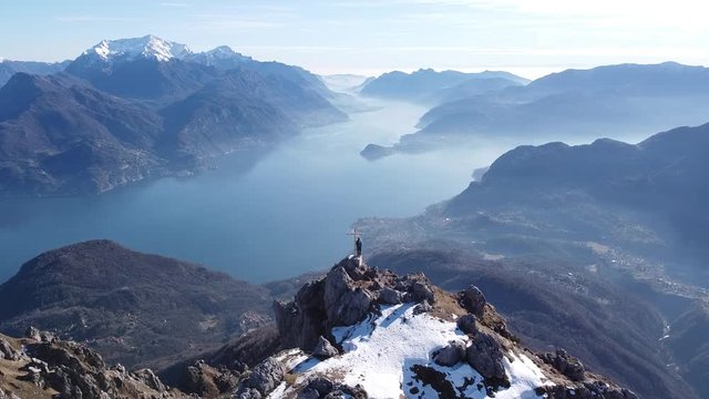 Flight around hikers on top of a mountain, European Alps, Como, Italy