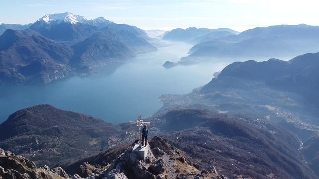 Flight around hikers on top of a mountain, European Alps, Como, Italy