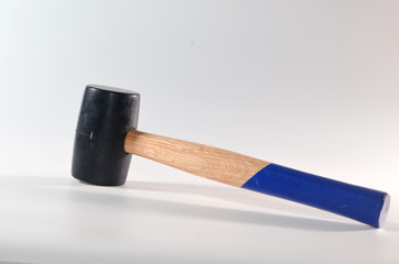 A rubber hammer with a blue wooden handle on a white background