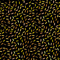 seamless pattern with confetti, sprinkles festive glitter. Brown yellow gold orange beige on black background. Can be used for greeting card design, Gift wrap, fabrics, wallpapers. Vector